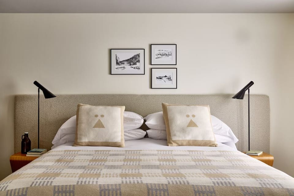Drift off in a serene bed framed by soft, modern lighting