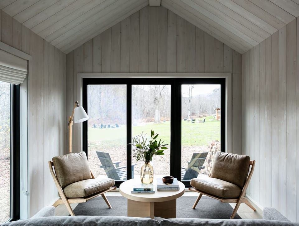 Sip morning coffee by expansive doors overlooking peaceful grounds.