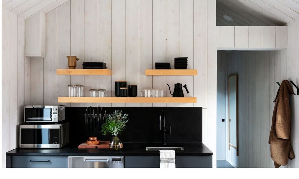 Cook with ease in a sleek kitchenette with open shelving.