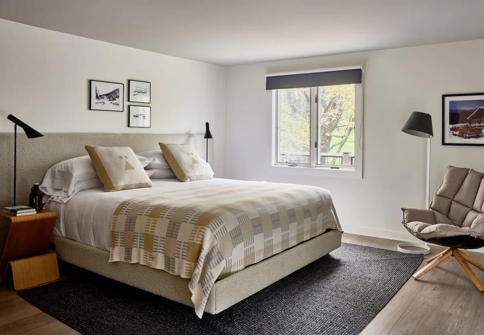 Unwind in a sunlit bedroom with plush linens and views.
