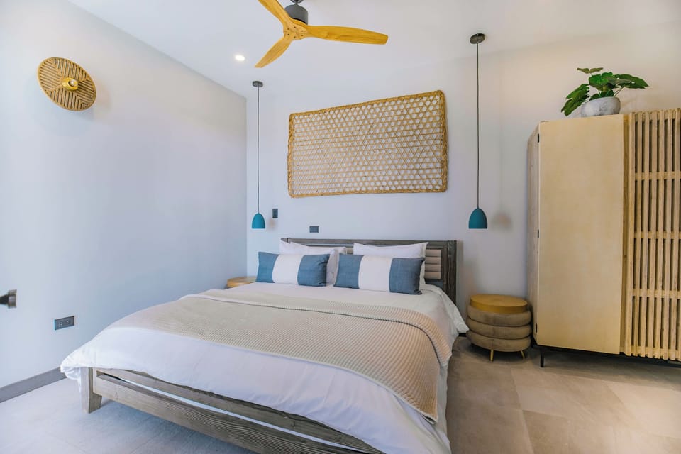 Unwind in crisp linens beneath the quiet ceiling fan.