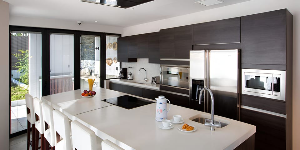 Cook together in a sleek chef’s kitchen with breakfast bar.