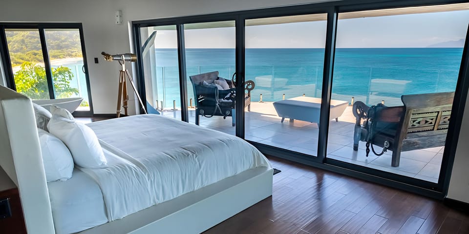Wake up to endless ocean views from your plush bed.