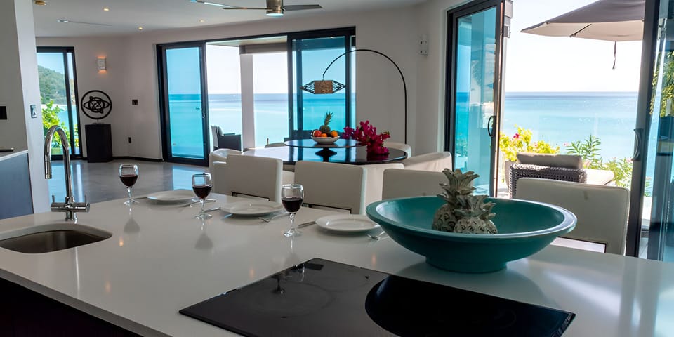 Gather for sunset drinks with sweeping sea views indoors.