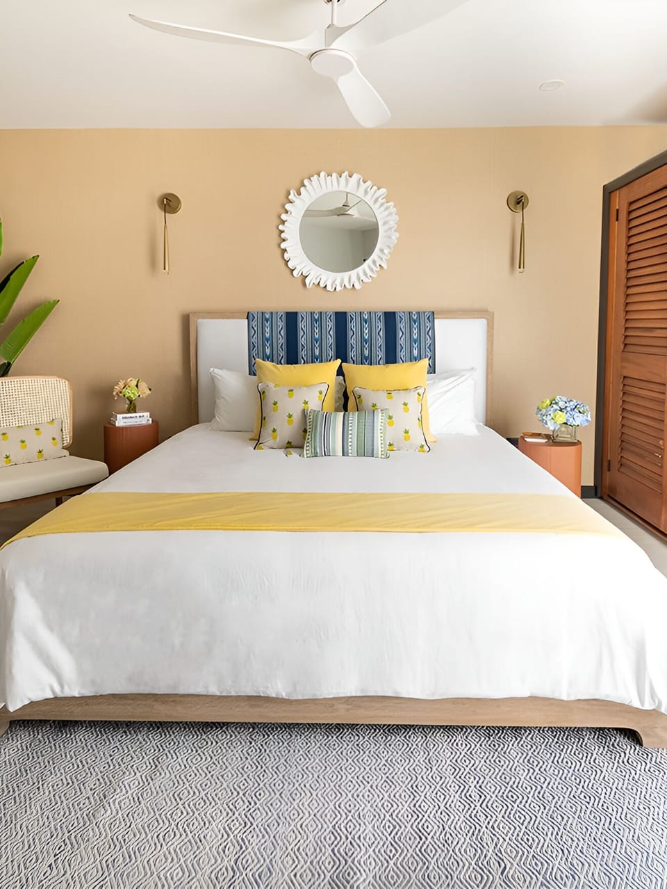 Unwind in crisp linens beneath a breezy ceiling fan.