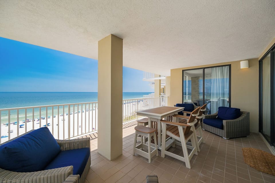 Relax on the spacious balcony with comfortable seating and breathtaking views of the pristine beach and tranquil waters