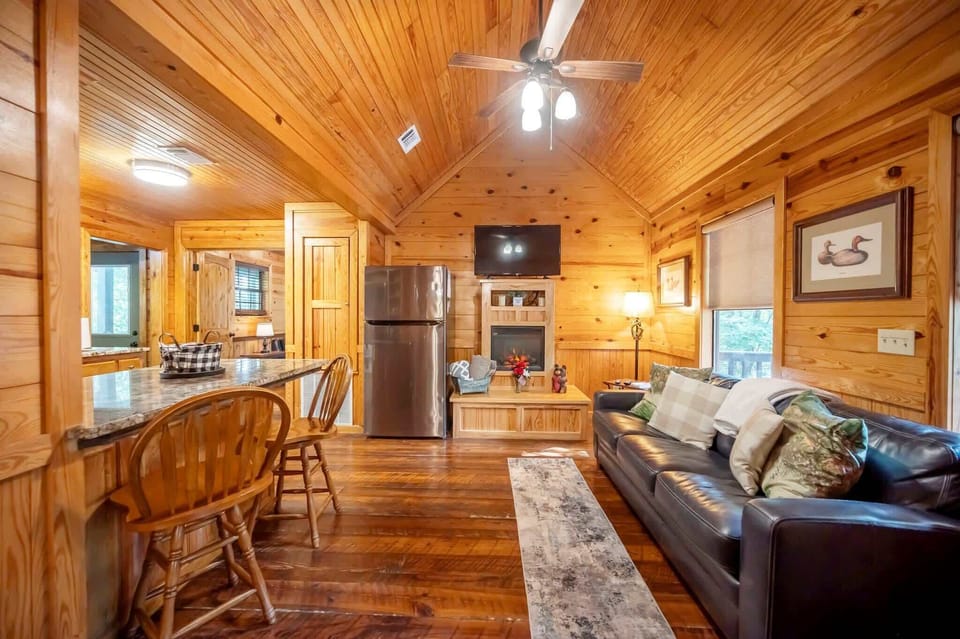 Step into the inviting living space with smart TV, fireplace, and queen sleeper sofa