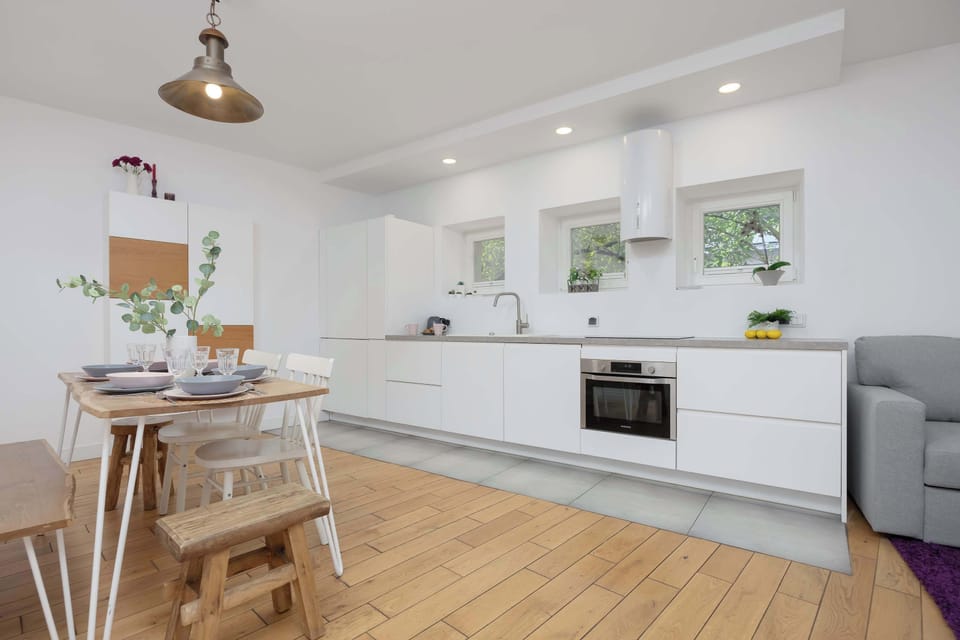  A bright living area with open layout, elegant flooring, and a neat interior design.