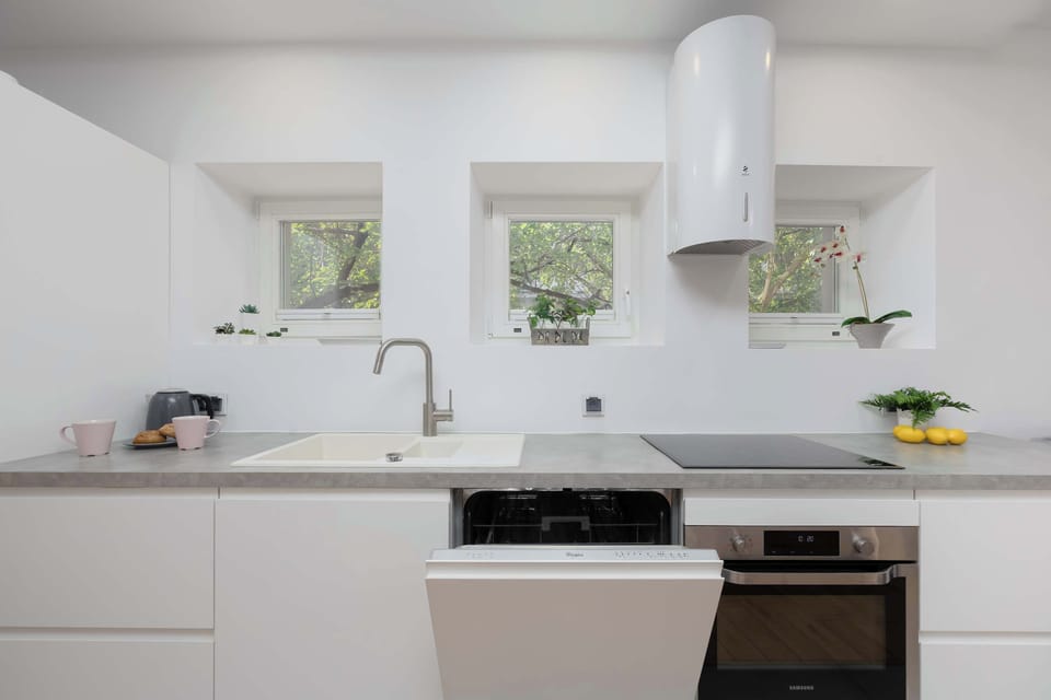  A well-lit meal prep area with a designer sink and a clean-lined aesthetic.