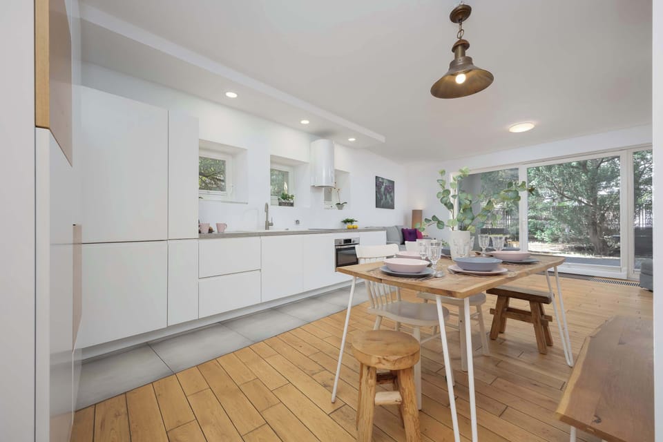 A modern kitchenette combined with a dining area, bright, spacious, and functional.