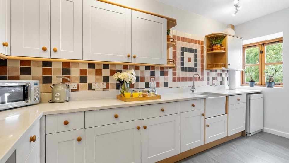 Light floods through the kitchen windows in this spacious set up.