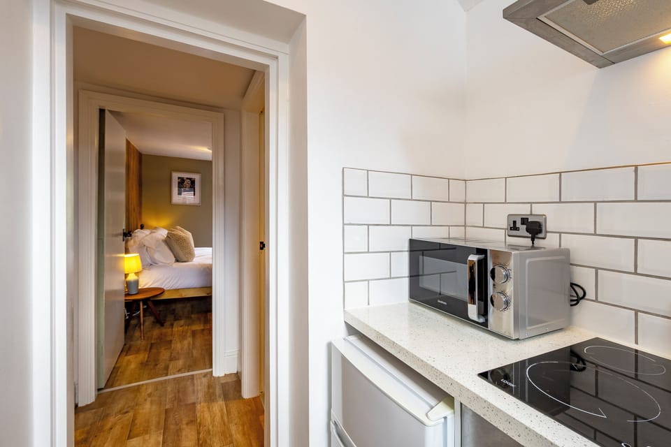 This kitchen features contemporary appliances, smart storage, and a clean, minimalist design.
