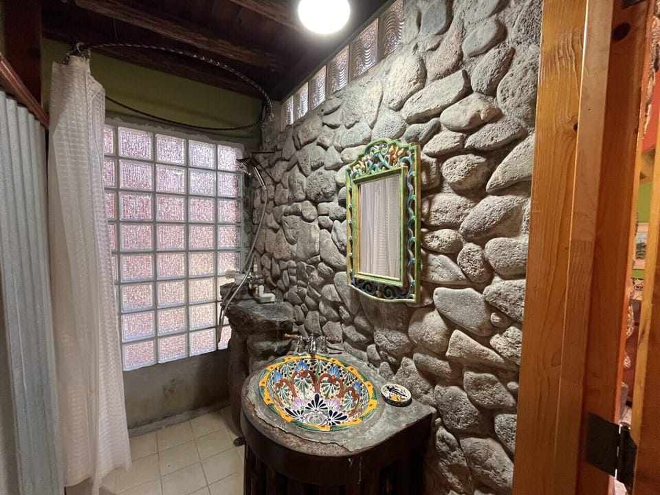 Eclectic, Mexican-inspired bathroom with shower