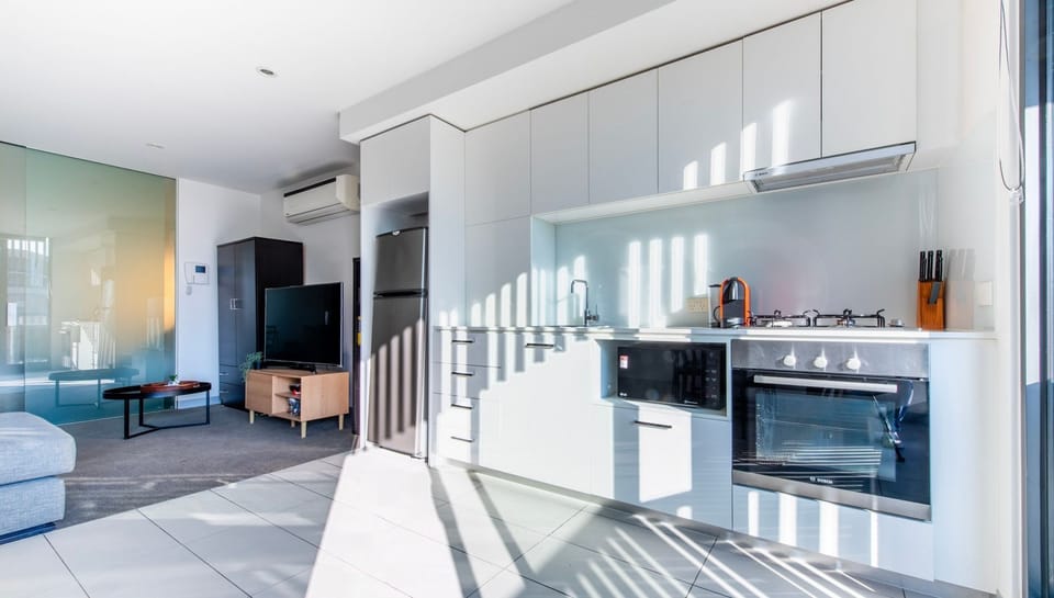 Sleek modern kitchen with glossy finishes and bright natural light.
