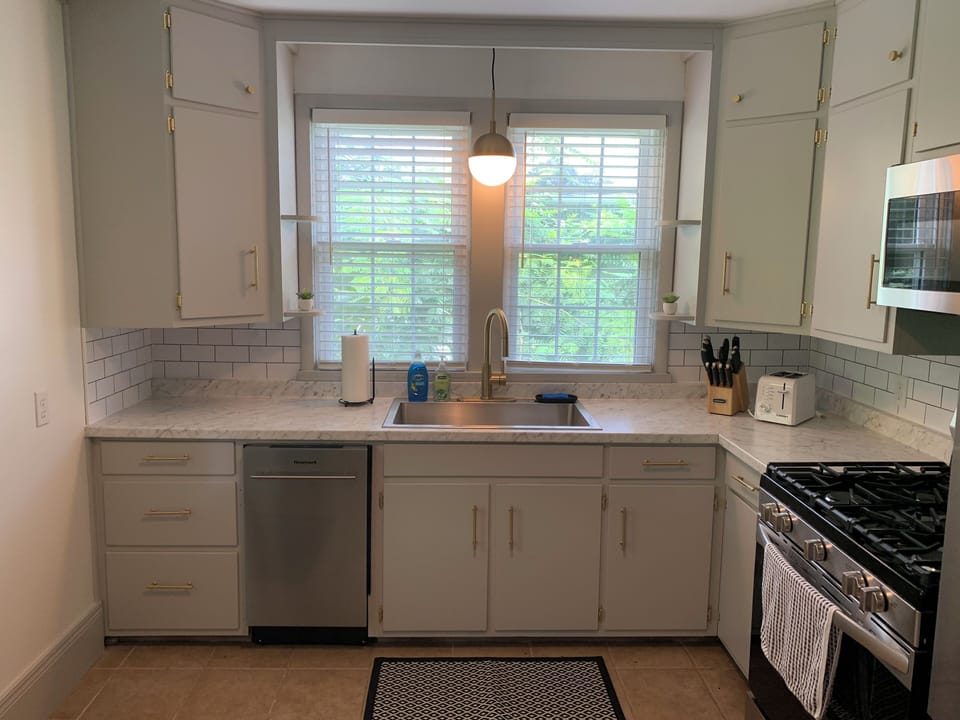 Kitchen features a full-size window and an oversized sink perfect for meal prep.