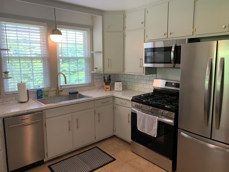 Updated kitchen with new counters, modern appliances, and compact dishwasher.