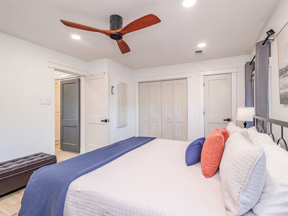 Spacious master bedroom featuring closet, drawers, and bedside lamps with USB charging—comfort and convenience in one.
