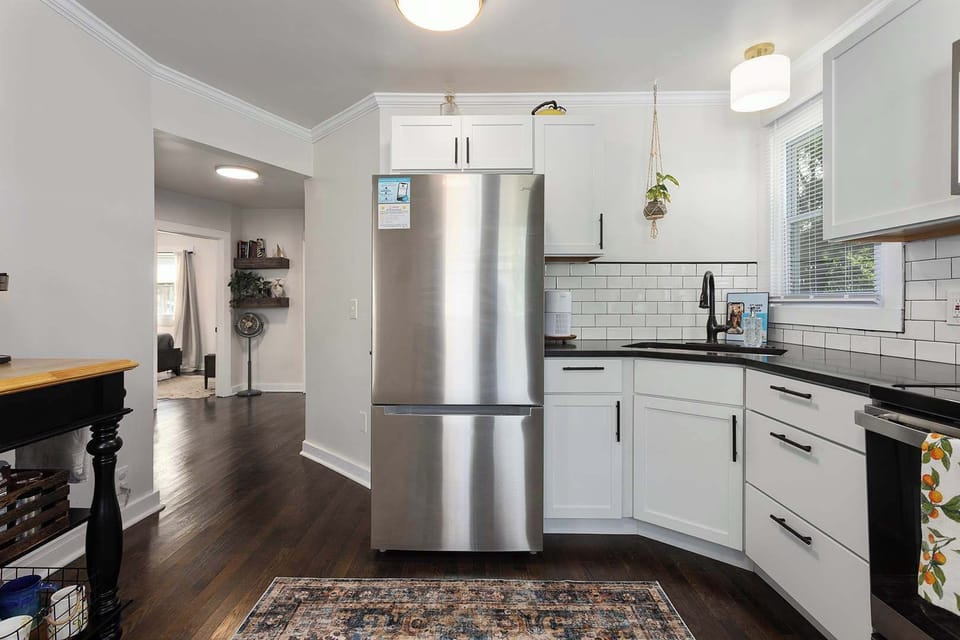Full kitchen with stainless steel refrigerator, electric stove, dishwasher and microwave/convection oven. New granite countertops and an island for additional space make this kitchen fully functional. Cleaning supplies under kitchen cabinet. 