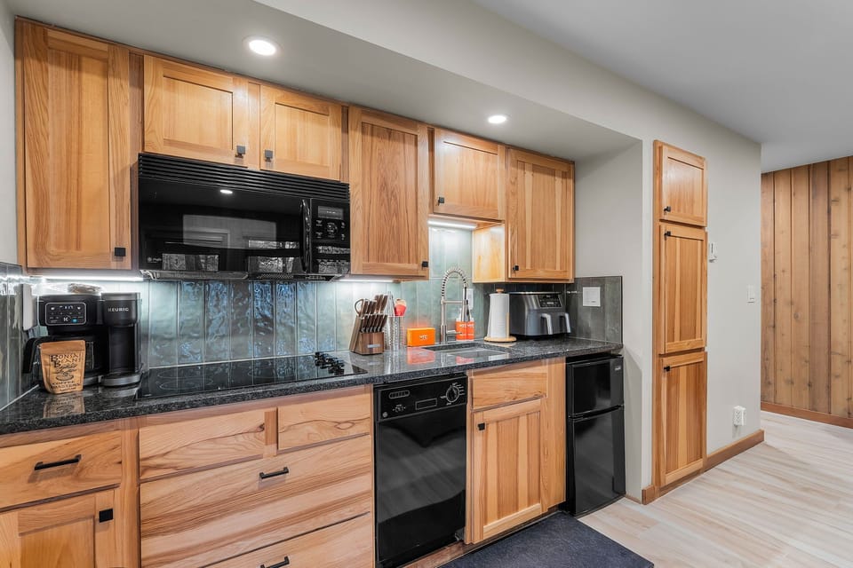 Kitchen is equipped with stove top, mini fridge, Ninja Air Fryer, microwave, Keurig/drop combo coffee maker