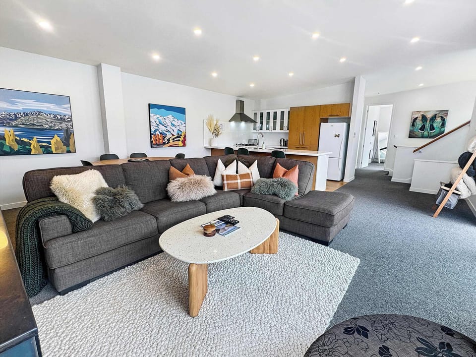 Spacious open-plan lounge with stylish décor and plenty of room to relax after a day exploring Queenstown.