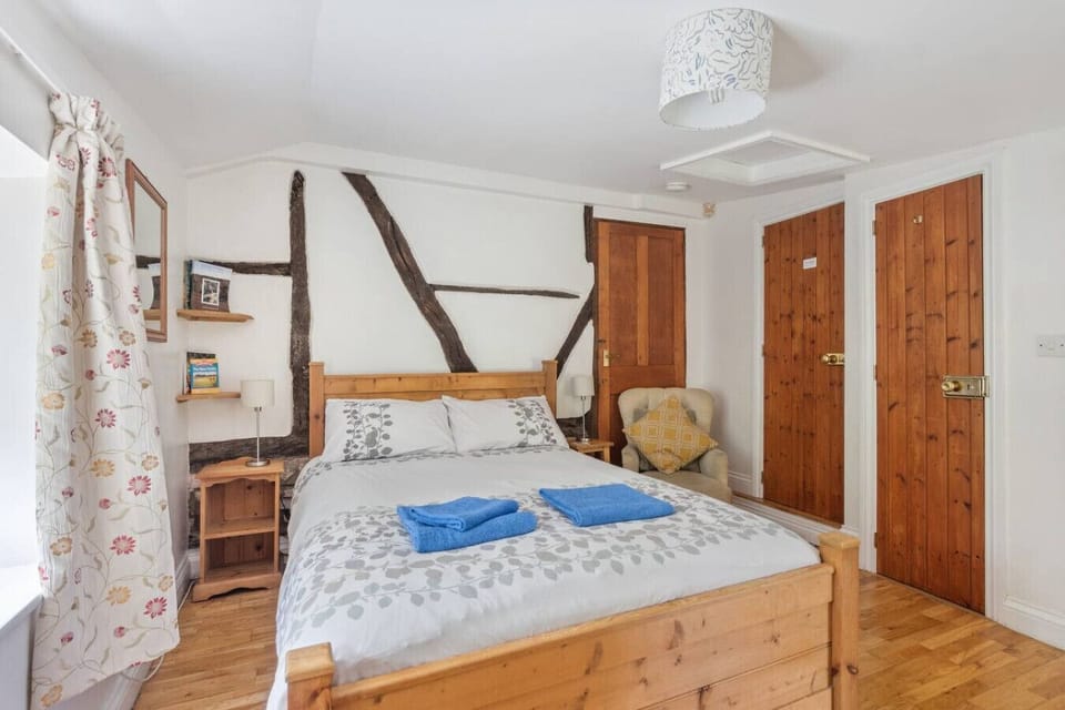 Cosy bedroom corner with vintage details and wooden floors
