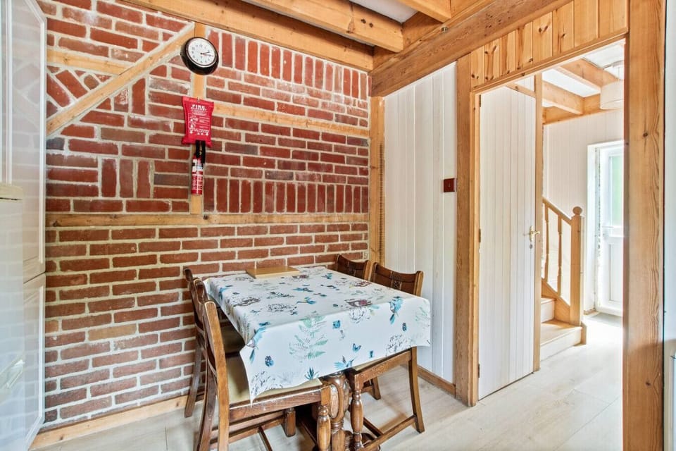 Rustic dining nook with exposed brick and natural light