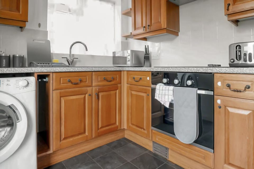 Fully equipped kitchen with wooden cabinetry