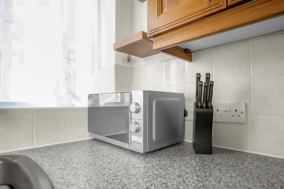 Microwave and knife set on the kitchen counter