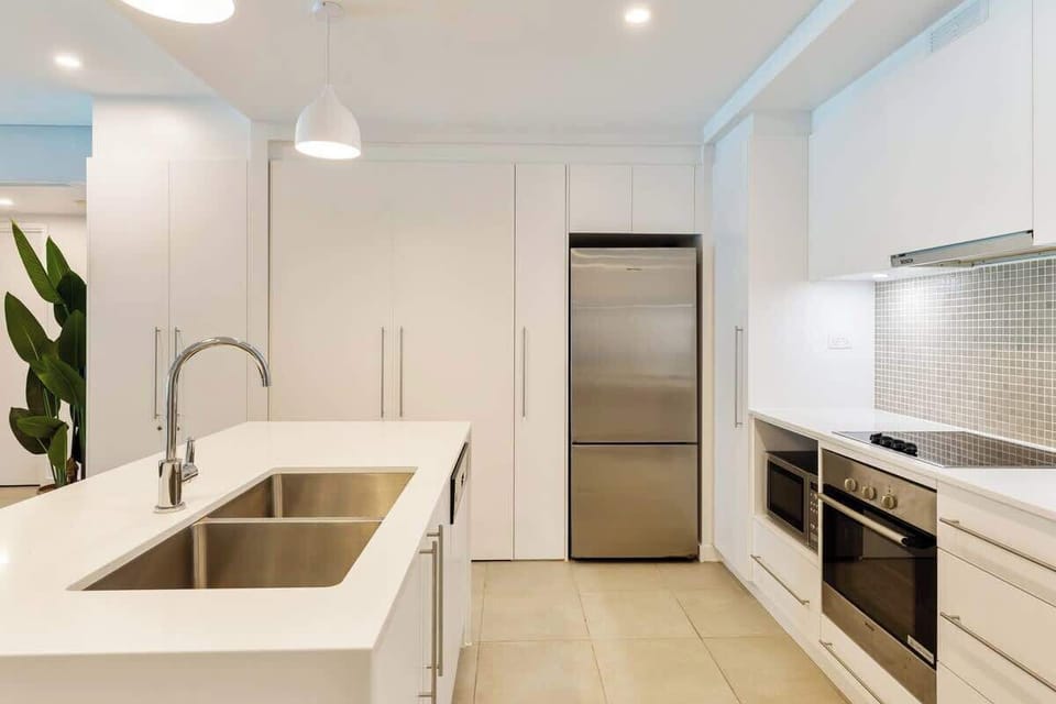 Cook with ease in the fully equipped kitchen, featuring an oven, microwave, dishwasher, full-sized fridge, and generous counter space for effortless meal prep.