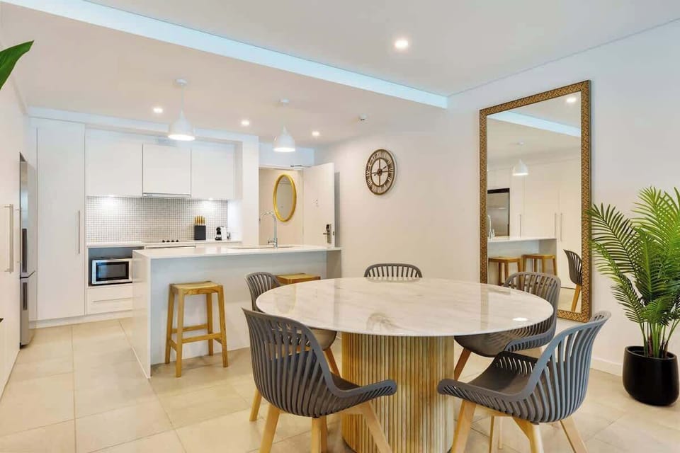 Gather around the stylish round dining table for a laid-back breakfast or evening feast, with a view stretching out to the private patio and pool beyond.