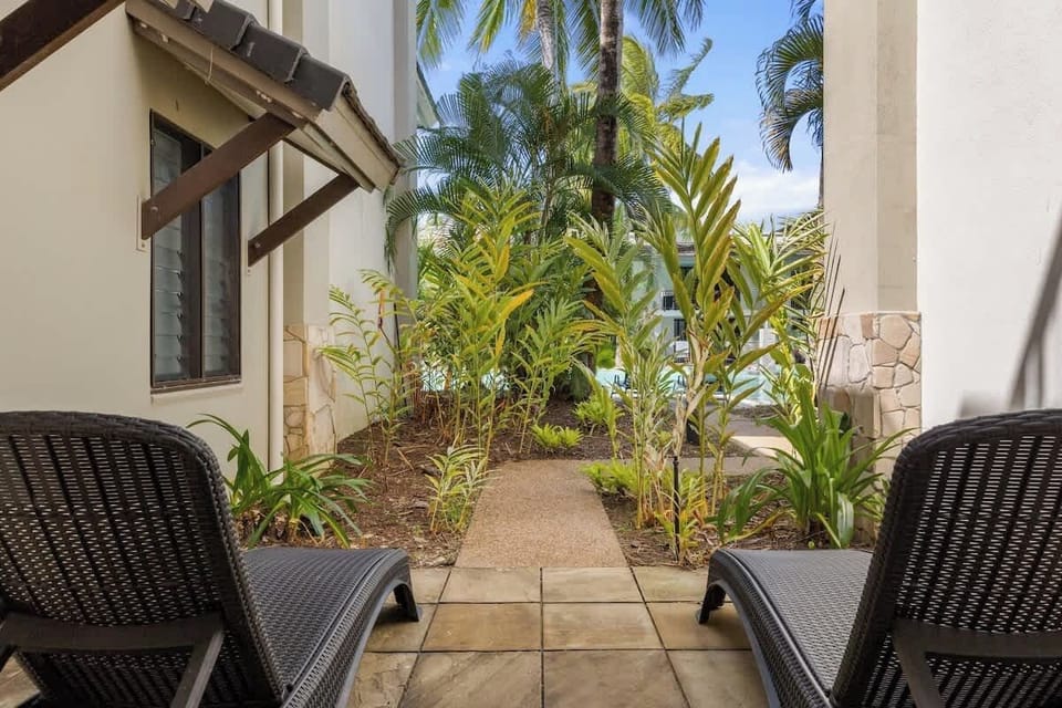 Unwind by the edge of the lagoon pool with sun loungers just outside your gated patio—ideal for soaking in sunshine and serenity.