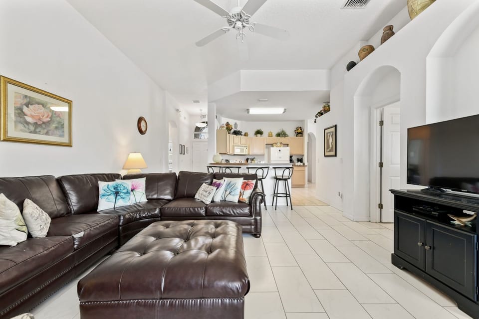 LIVING ROOM:  50” Flat Screen TV, Ceiling Fan and Direct Access to Pool/Patio Area