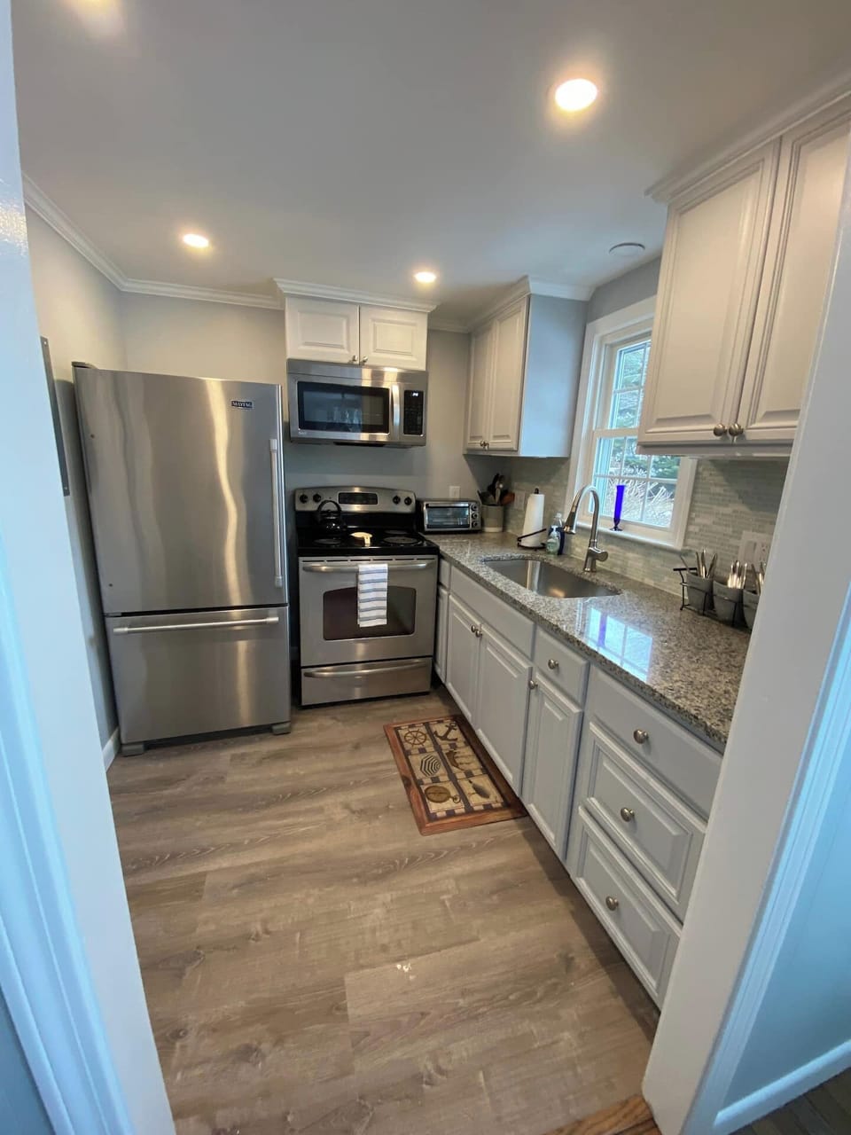 Kitchen equipped with Fridge, stove, microwave, toaster oven, coffee pot.  Pots, pans utensils.....