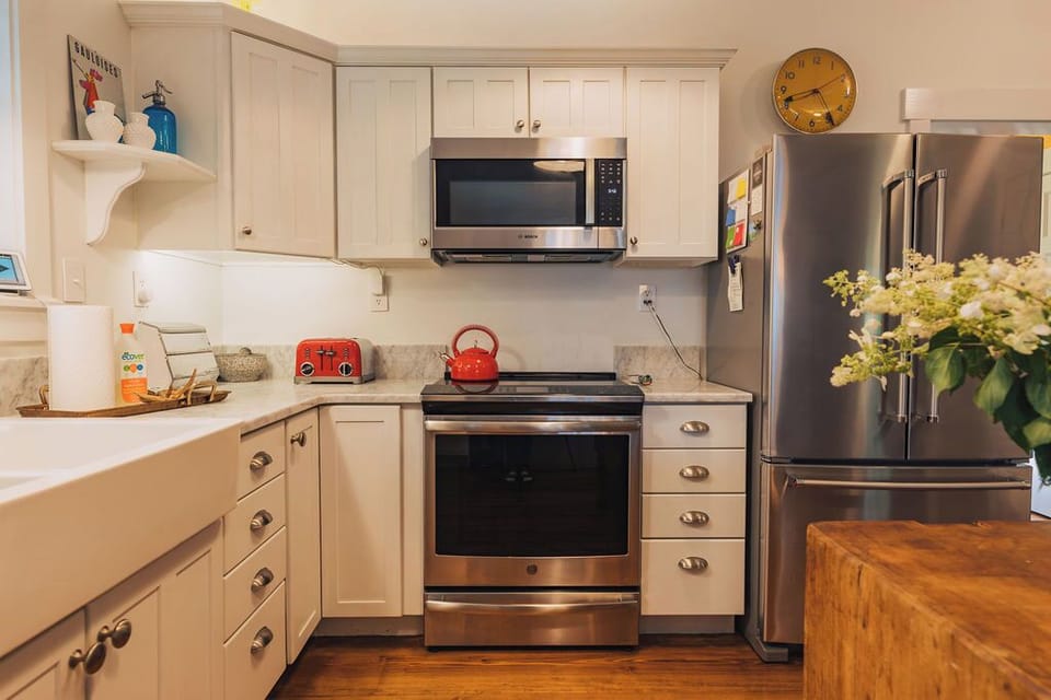 Classic farmhouse kitchen with all of the kitchen tools and appliances including induction range with convection oven to make a home cooked feast. 