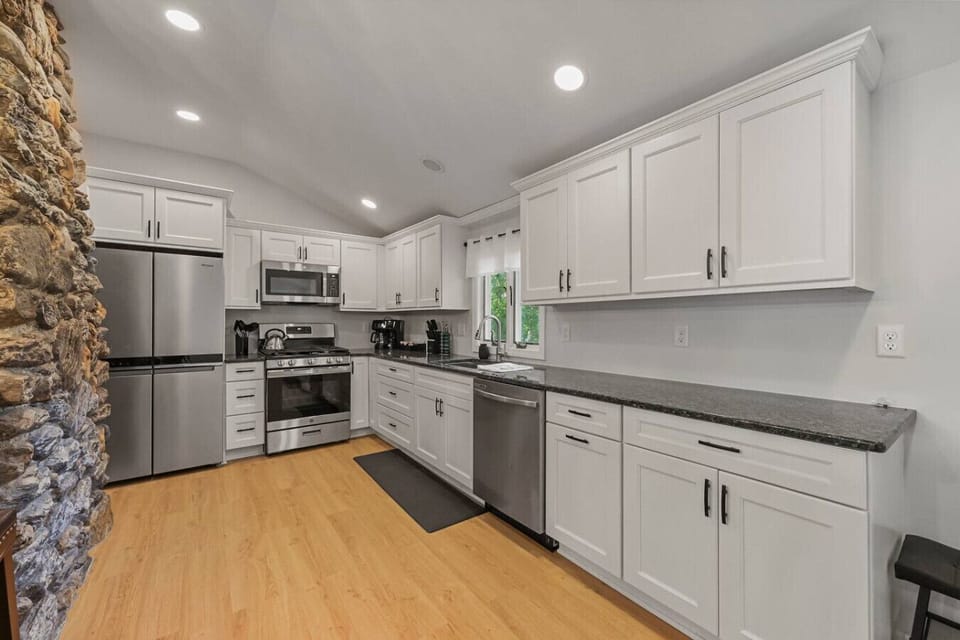 Granite countertops with a large island for meal prep and gatherings.