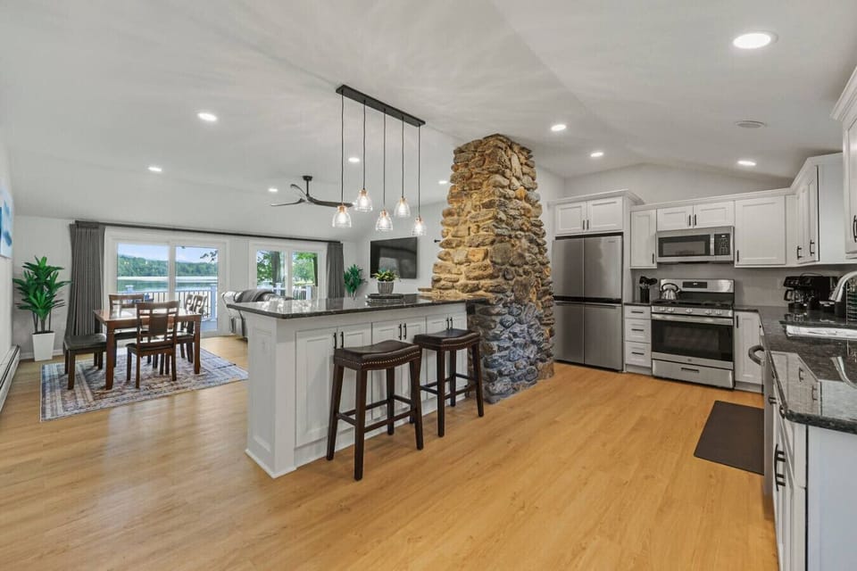 Spacious kitchen with stainless steel refrigerator, oven, microwave, and dishwasher.