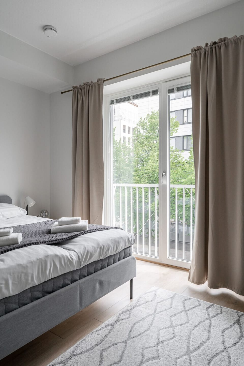 The apartment features a French balcony that brings in plenty of natural light and a sense of openness