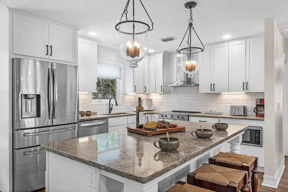 kitchen island and fully stocked with appliances and dishware.
