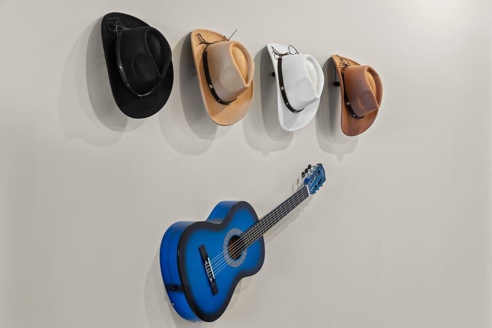 - Wall display with cowboy hats and guitar adding unique charm  
- Fun accent decor creating a memorable touch for guests  
- Stylish design enhancing the home’s personality  