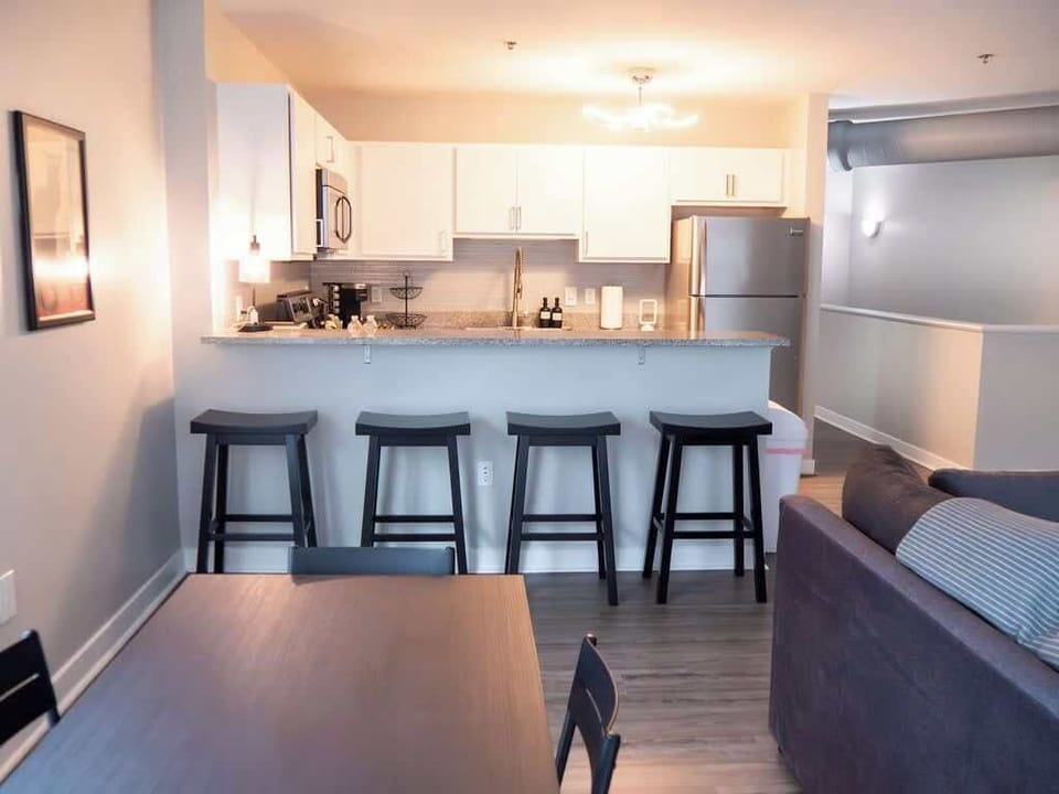 - Modern shared kitchen with stainless appliances and bar seating
- Downtown apartment rental with full cooking setup
- Spacious open layout ideal for extended stays
