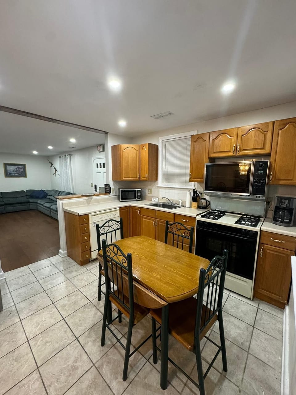 microwave, coffee maker, kitchen, oven, refrigerator, stovetop, table