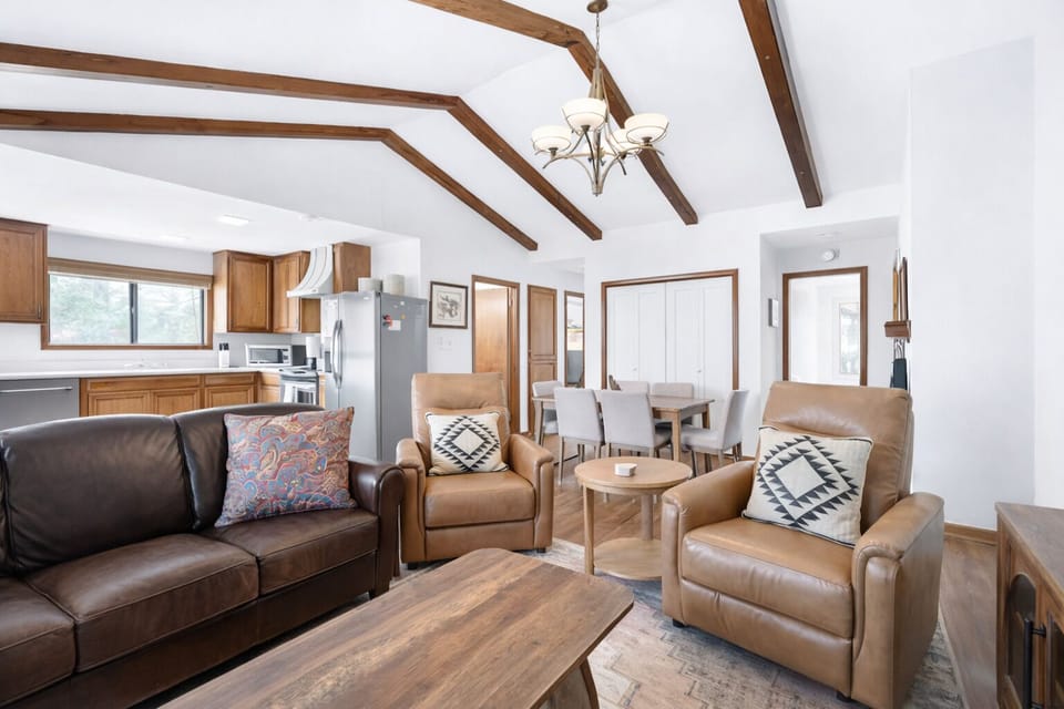 Open-plan retreat with beams, leather seating, dining area and modern kitchen