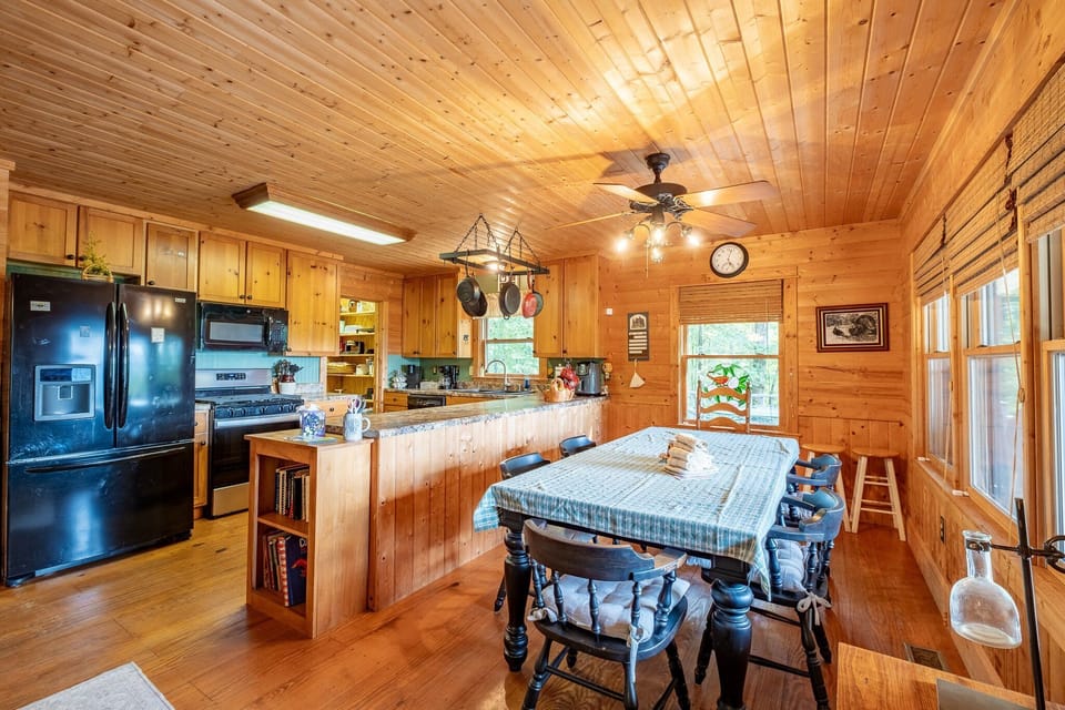 The dining area at this Bryson City vacation rental offers seating for a group and direct access to the kitchen, creating a convenient setup for shared meals.