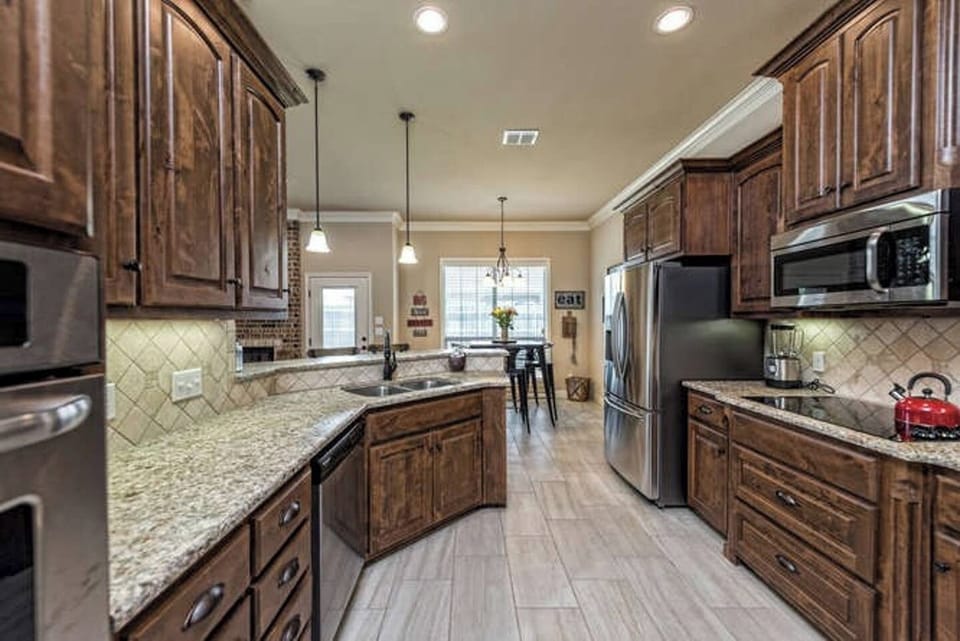 Cook, sip, savor in the spacious kitchen with granite countertops, stainless steel appliances.