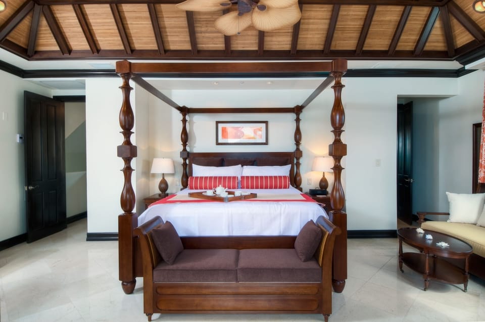Sink into a grand canopy bed beneath airy timber ceilings.