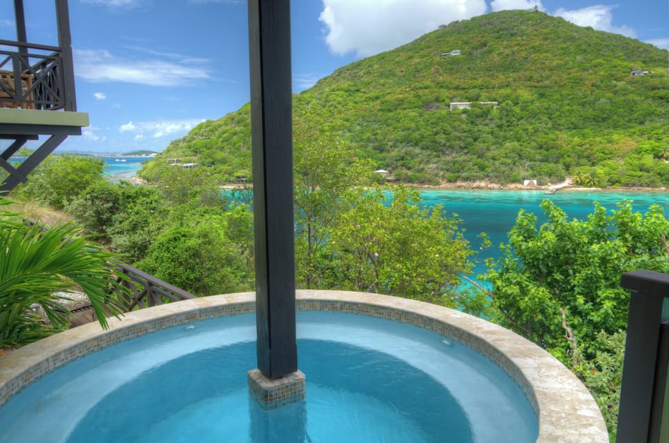 Soak in bubbling bliss with sweeping turquoise bay views.