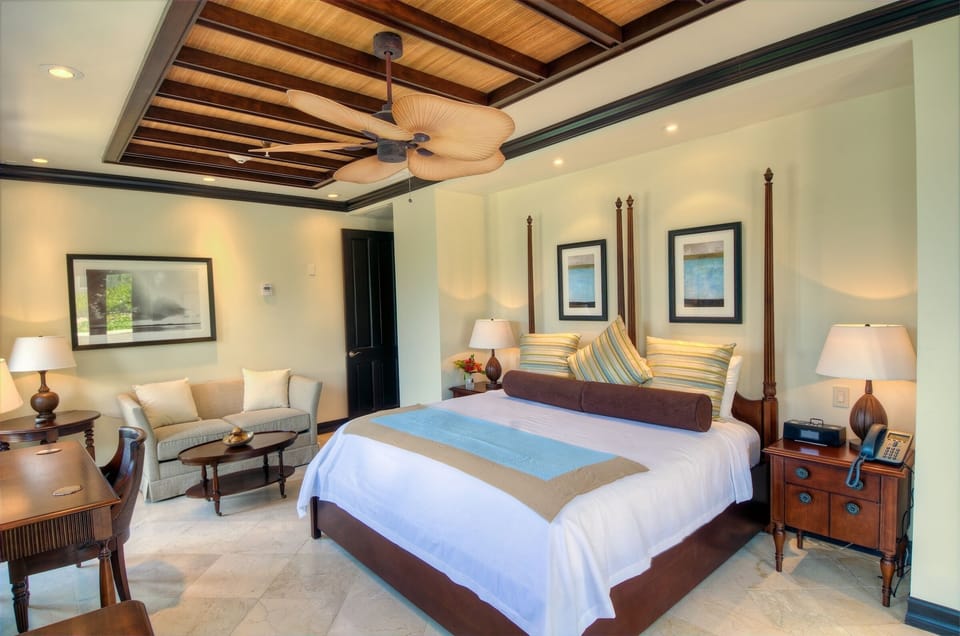 Unwind in a serene king bedroom with island-inspired warmth.