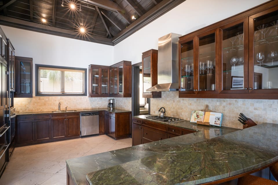 Cook effortlessly in a chef’s kitchen with rich wood finishes.