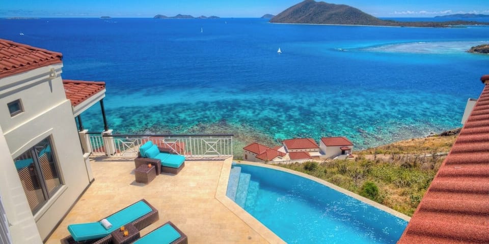Dive into the infinity pool above dazzling Caribbean blues.