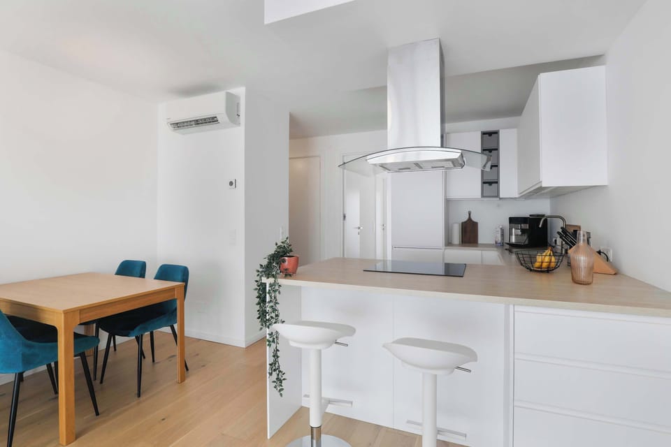 Open Kitchen with Island Seating, Air Conditioning, and Natural Light